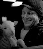 Founder Tom Kay holding Merino lamb