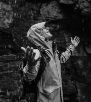 Model wearing a Finisterre waterproof jacket in the rain